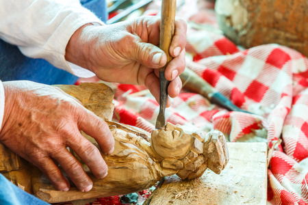 Hand of carver carving woodの写真素材