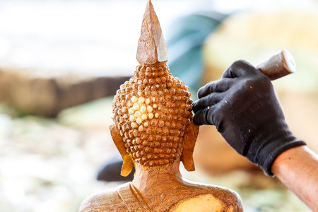 Hand of carver carving wood