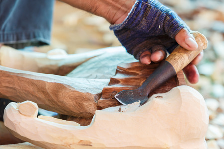 Hand of carver carving woodの写真素材