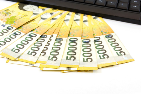 Korea money with keyboard on white backgroundの写真素材