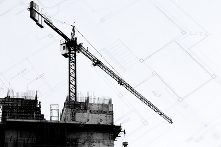 Construction site with cranes on silhouette backgroundの写真素材