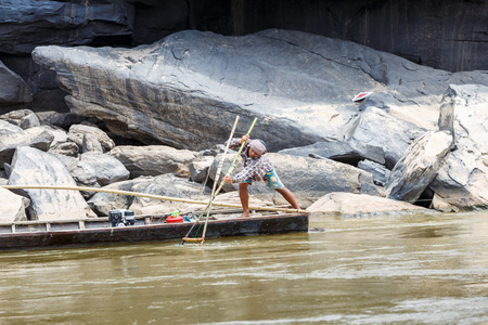 LAO - MARCH 27 2015: Local fisherman catch fish in khong river at Thailand and Lao border on March 27, 2015.のeditorial素材