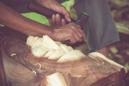 Hand of carver carving wood in black and white color toneの写真素材
