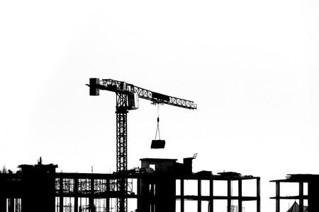 Construction site with cranes on silhouette backgroundの写真素材