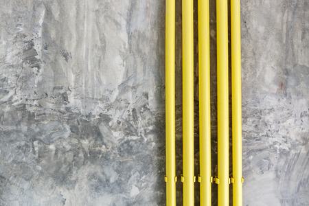 Loft style wall texture background with yellow pipeの写真素材