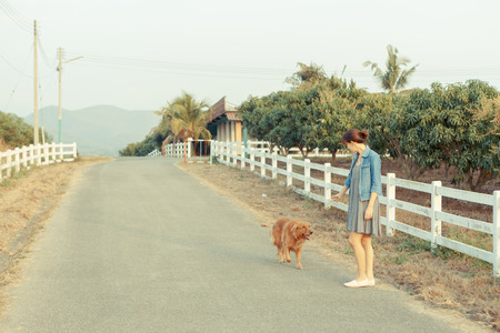 Beautiful woman with a cute golden retriever dogの写真素材