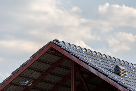 roof under construction with stacks of roof tiles for home building