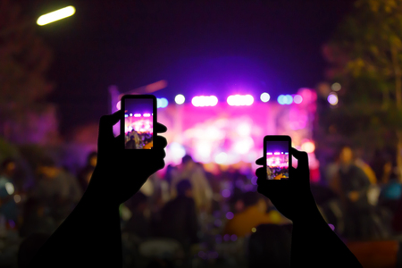 silhouette crowd in front of concert stage blurredの写真素材