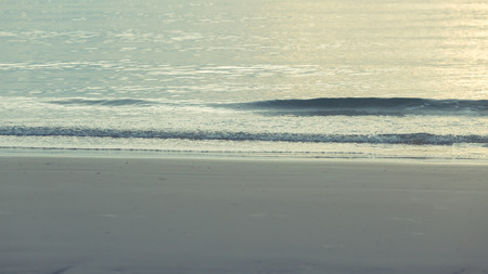 Sea wave on the beach with sunlight in morningの写真素材