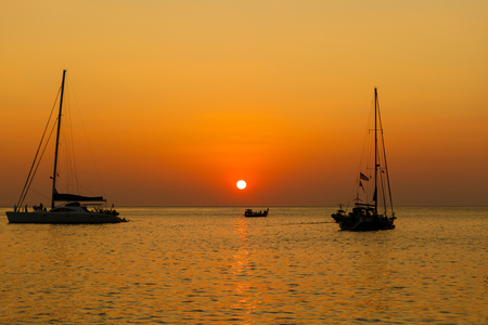 Sunrise on the sea with boatの写真素材