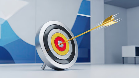 A close-up view presents an arrow precisely striking the center of a target. The metallic arrow and target exhibit vibrant colors and a three-dimensional effect. The setting appears to be an interior space, with an out-of-focus chart in the background. This image is suited for illustrating concepts related to business success or strategic goals.の素材