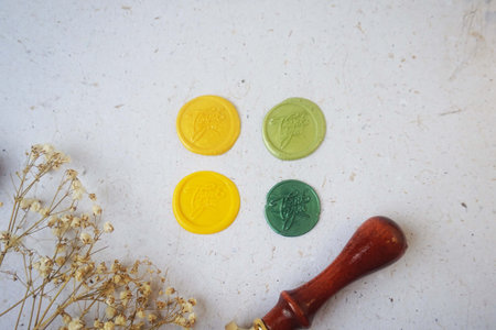 Colorful pretty wax seal stamps coin on white paper background, vintage style for wedding or invitation decoration. Top view. Flat lay. copy spaceの写真素材