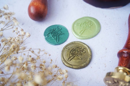 Colorful pretty wax seal stamps coin on white paper background, vintage style for wedding or invitation decoration. Top view. Flat lay. copy spaceの写真素材