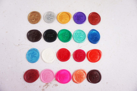 Colorful plastic buttons on a white background, top view, copy spaceの写真素材