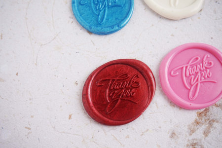 Close up of colorful wax seal stamp on white paper background, vintage styleの写真素材