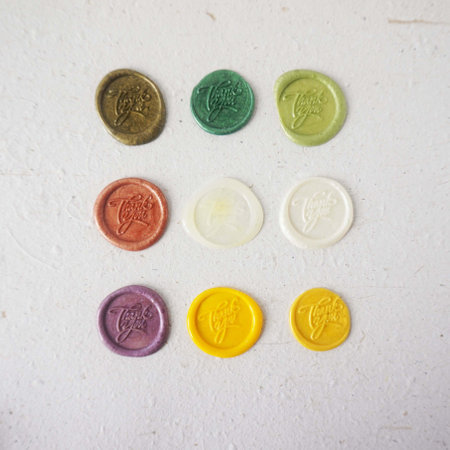 Colorful wax seal stamps on a white background, closeup of photo on white background, top view, copy spaceの写真素材