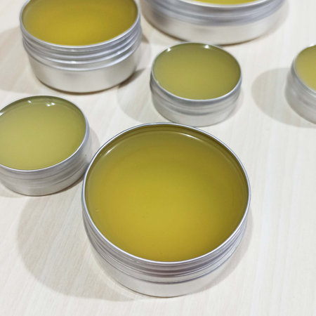 Can of homemade balml in a row on a wooden table, top viewの写真素材