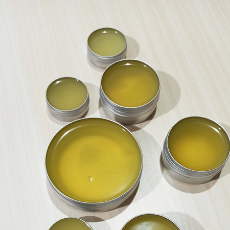 Cans of homemade balm on a wooden table. Top view.の写真素材
