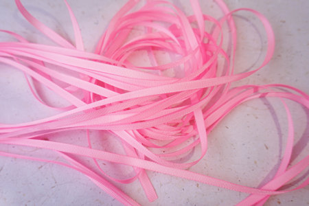 Pink ribbons on a white background. Shallow depth of field.の写真素材