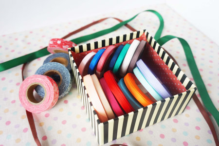 Colorful ribbons in gift box on white background. Selective focus.の写真素材