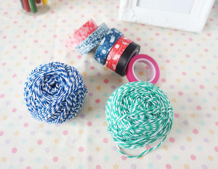 Colorful yarn balls and sewing accessories on polka dot background.の写真素材