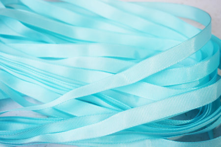 Blue ribbons on a white background. Close-up. Selective focus.の写真素材