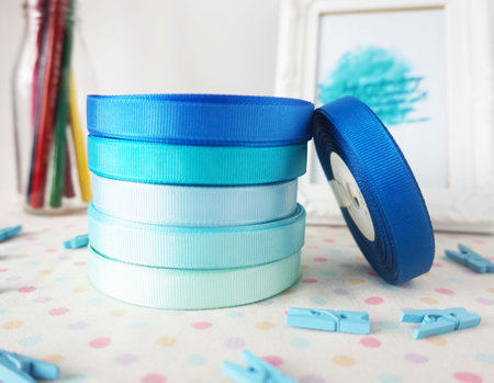 Rolls of blue and green satin ribbons on white backgroundの写真素材