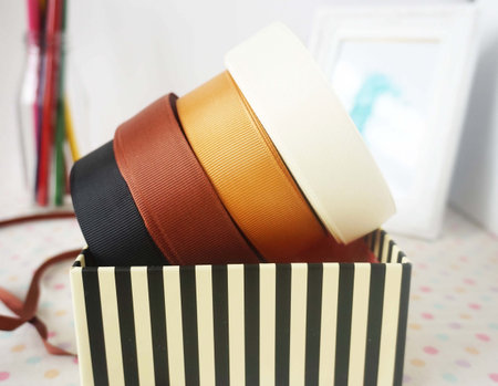 Colored ribbons in a gift box on a white background.の写真素材