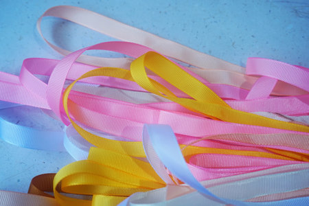 Colorful ribbons on blue background. Selective focus. Toned.の写真素材