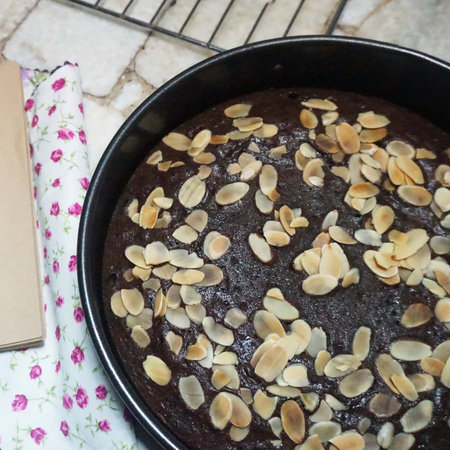 Homemade chocolate cake with almonds in a baking dish on the tableの写真素材