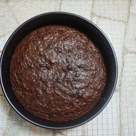 Chocolate muffin in a black bowl on a white background.の写真素材