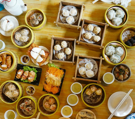 Chinese dim sum set in wooden box on table, top view.の写真素材