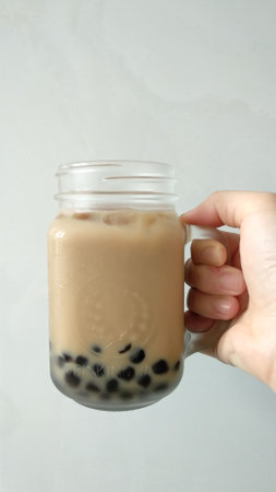 Taiwan milk tea with bubble in a glass on white background.の写真素材