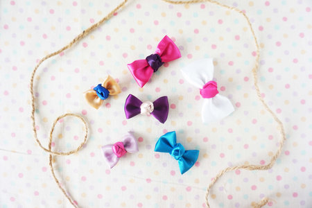 Colorful bows on polka dot background. Flat lay, top view.の写真素材