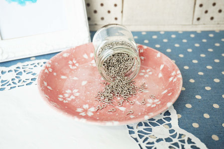 Vintage table setting with silver chain in a glass jar. Selective focus.の写真素材