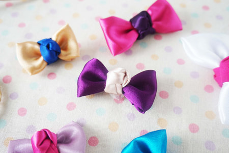 Colorful bow ties on polka dot background, close-upの写真素材