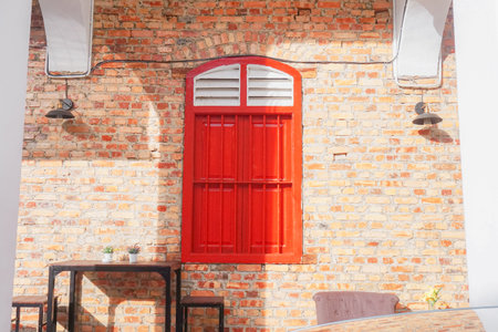 Red wooden window on brick wall background with copy space for add textの写真素材