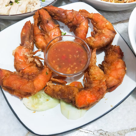 Fried shrimp with chilli sauce on white plate, Thailand.の写真素材