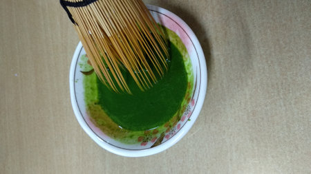 Japanese matcha green tea in a bowl with chopsticks, top viewの写真素材