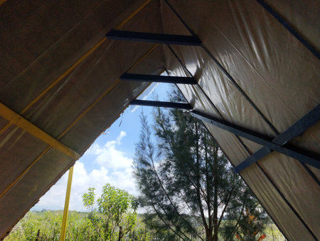 Tent on the hill in the countryside with clear blue sky and white clouds. of Indonesia, view from insideの写真素材