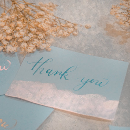 Thank you card with dried flowers on a rustic background. Vintage style.