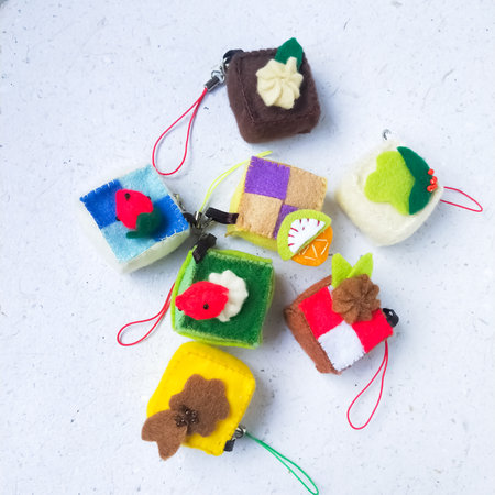 Handmade woolen toy chicken on a white background close-up