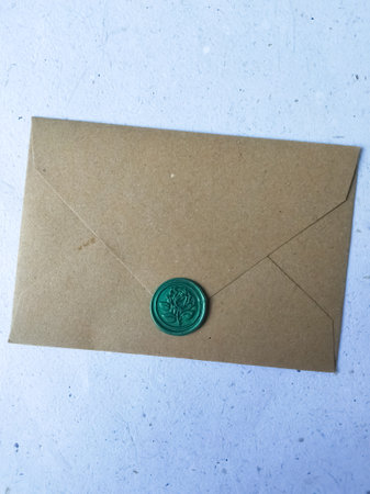 Envelope with a green wax seal on a white background.