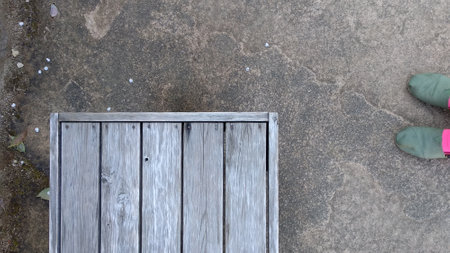 Top view of wooden chair on cement floor with copy space for text