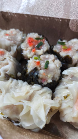 Steamed dumplings stuffed with meat and vegetables in a boxの写真素材