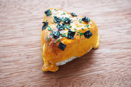 Baked chicken with cheese on a wooden background.