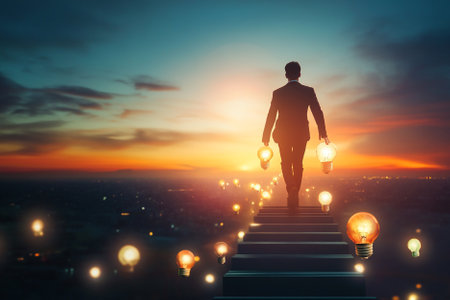 Back view of businessman standing on stairs and looking at bright glowing lightbulbs. Success conceptの写真素材