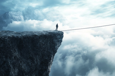 Silhouette of a person standing on the edge of a cliff.の写真素材