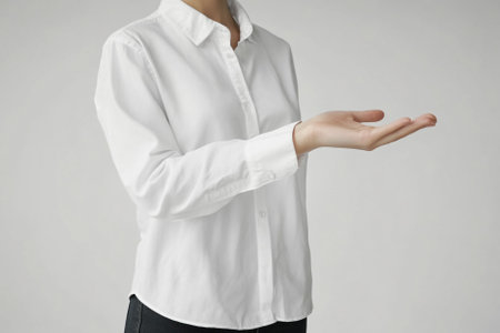 Businesswoman showing something on the palm of her hand, white backgroundの写真素材