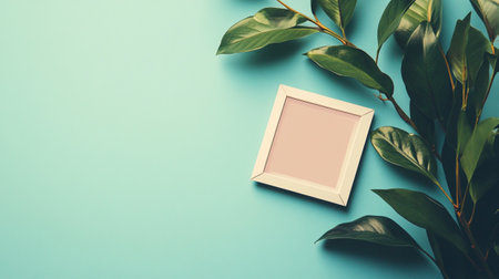 Creative flat lay top view mockup photo frame with green leaves on pastel turquoise background with copy space. Minimal nature concept template for feminine blog or social mediaの写真素材